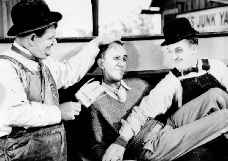 Stan and Ollie with director George Marshall during filming of Towed In A Hole 1932